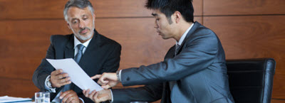 Two men discussing in a meeting room.