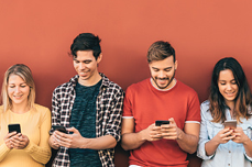 Group of people looking at their phones using our Mobile Banking